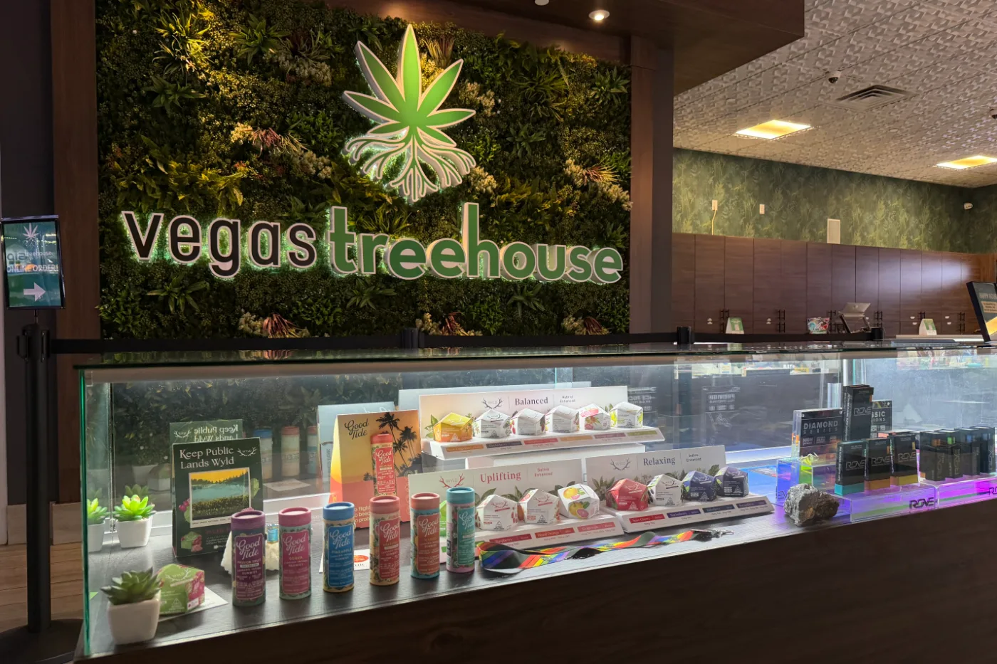 The front display case beneath the illuminated Vegas Treehouse sign and its living wall.